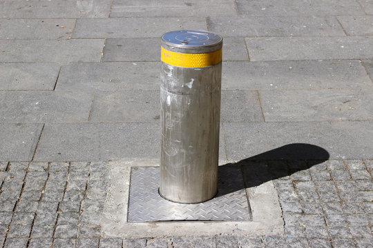 Retractable bollard street pavement sidewalk cobblestone