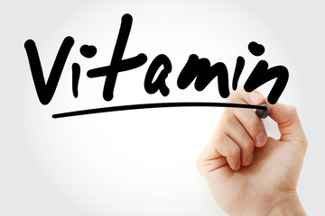 Vitamin text with marker, health concept background