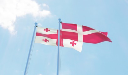 Georgia and Denmark, two flags waving against blue sky. 3d image