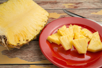 Close up of freshly sliced pineapple on a rustic table