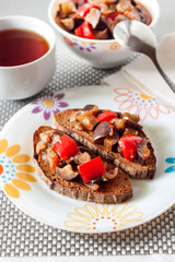 Vegetable stew with eggplant, red pepper and tomatoes on toasted rye bread