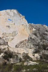 Fototapeta na wymiar Apuan Alps, Carrara, Tuscany, Italy. A quarry of white marble. The precious white Carrara marble has been extracted from the Alpia Apuane quarries since Roman times. 