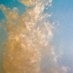 inked paint in water gold paint explosion in water brilliant, particles