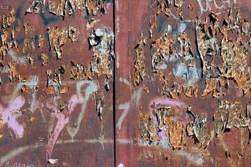 Rusty old red brown steel fence graffiti fragments surface texture 