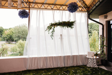 Arch for the ceremony of fabric. Wedding day. Blue pom-poms.