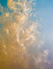 inked paint in water gold paint explosion in water brilliant, particles