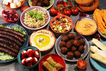 Middle eastern or arabic dishes and assorted meze, concrete rustic background. Falafel. Turkish...