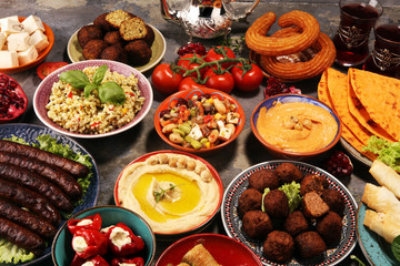 Middle eastern or arabic dishes and assorted meze, concrete rustic background. Falafel. Turkish Dessert Baklava with pistachio. Halal food. Lebanese cuisine