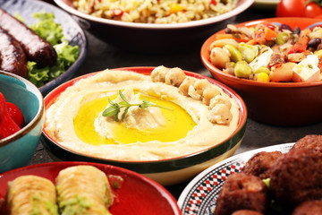 Middle eastern or arabic dishes and assorted meze, concrete rustic background. Falafel. Turkish Dessert Baklava with pistachio. Halal food. Lebanese cuisine