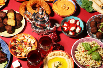 Middle eastern or arabic dishes and assorted meze, concrete rustic background. Falafel. Turkish Dessert Baklava with pistachio. Halal food. Lebanese cuisine