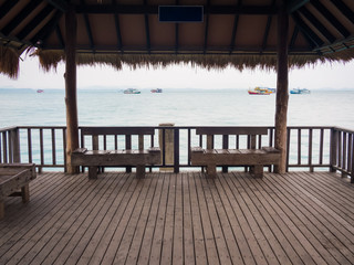 Two wooden empty benches at a pier in Thailand