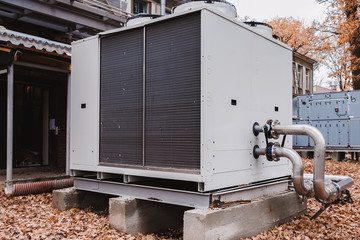 Industrial stainless steel pipes connected to the commercial cooling unit for the HVAC systems