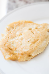 one fresh pancake on white plate