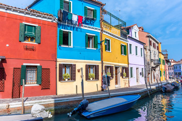 Naklejka na ściany i meble Italy, Venice, Burano, canals and boats among the typical colored houses.