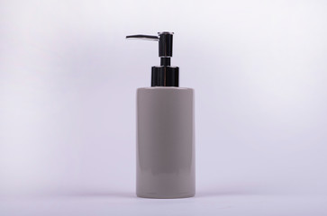 Fototapeta na wymiar Dispenser for liquid soap on a light background. Hygiene products.