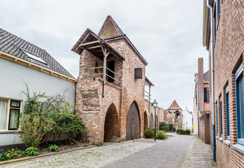 Fototapeta na wymiar Ancient city wall with a small house in Zutphen, a medieval city along the river IJssel in Gelderland in the Netherlands