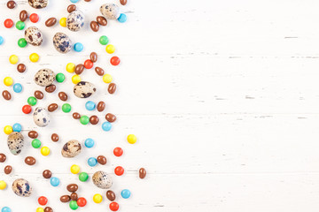 Easter frame with chocolate eggs, colorful candies