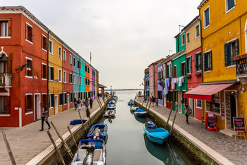 Fototapeta premium Italy, Venice, Burano, canals and boats among the typical colored houses.