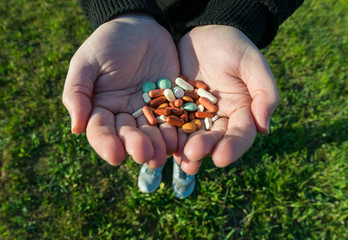 Girl's hands holding pills