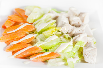Fresh delicious healthy salad with celery, carrot and meat on white