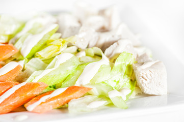 Fresh delicious healthy salad with celery, carrot and meat on white