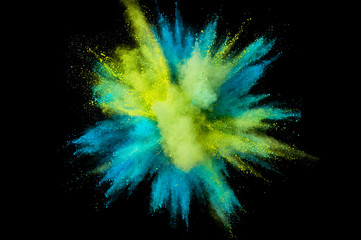 Colored powder explosion. Abstract closeup dust on backdrop. Colorful explode. Paint holi