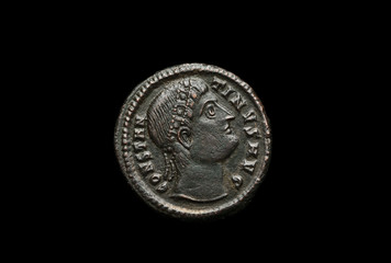 Ancient roman coin with portrait of emperor isolated on black