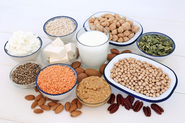 Vegan health food selection with bean curd, legumes, nuts, seeds, cereals, sos mix, almond milk, butter and yoghurt. Super foods high in antioxidants, protein, vitamins and dietary fibre.
