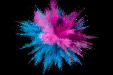 Colored powder explosion. Abstract closeup dust on backdrop. Colorful explode. Paint holi