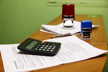 Black calculator with papers in the office