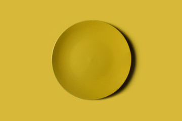Yellow plate on a plate backgroung. Deep shadow. Postcard, Design. Pace for text, copy space.