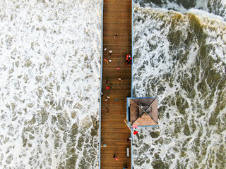 Aerial view of San Clemente Pier with lifeguard tower for surfer. San Clemente city in Orange County, California, USA. Travel destination in the South West Coast. Famous beach for surfer. 