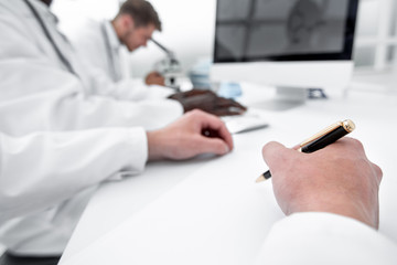 close-up of the scientist makes a record sitting at the laboratory table