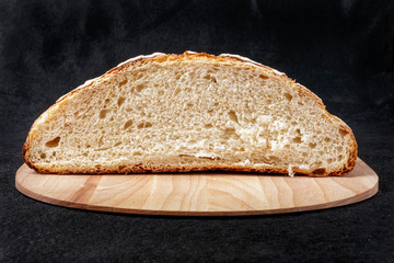 Handmade yeast-free bread on black background. Front view.