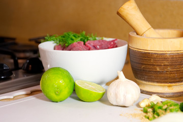 Food preparation, meat with condiments. on white table