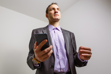 Businessman sending message in his mobile phone