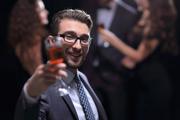 elegant man raising a glass of champagne