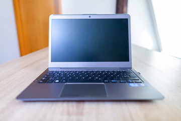 Fototapeta premium A clean laptop stands on a table