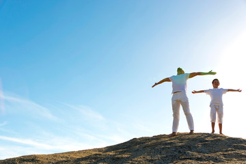 Father and son breathing on top of hill