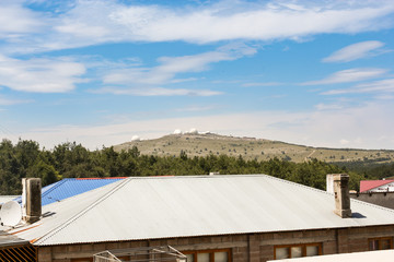 Top of the mountain above the roof.