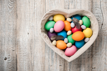 Obraz premium Easter eggs in heart shaped basket