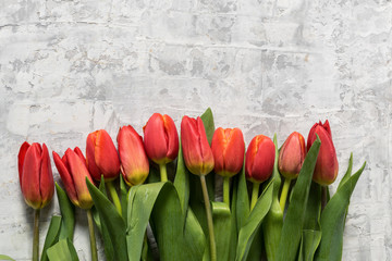 Big bouquet of spring tulip flowers over gray background.