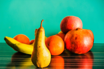 Winter fruits of Provence in the room on the table against the background of the green mint wall.