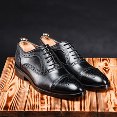 leather stylish men's shoes on a black background