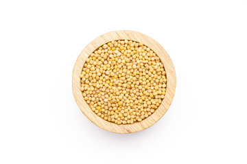 Lot of whole white mustard seeds with wooden bowl flatlay isolated on white background