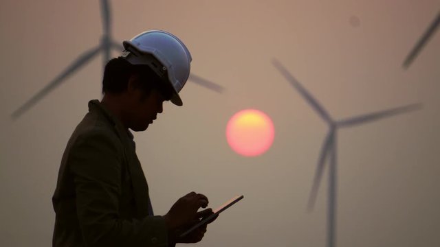 Senior Engineer, Asian are monitoring system wind turbine electricity generation with teblet footage 4K