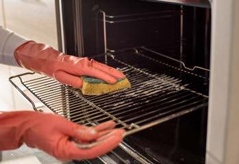Woman cleaning oven