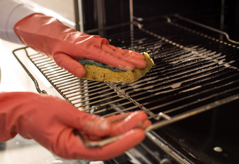 Woman cleaning oven
