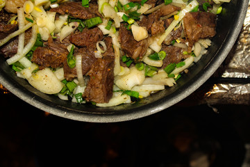 Juicy beef, roasted on low heat, with seasoned, greens and onions.