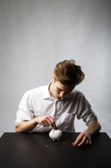 Young man and piggy bank.